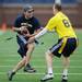 Darren Petterson looks to run the ball by Colby Keefer during the Victors Classic alumni football game at Michigan Stadium on Saturday. Melanie Maxwell I AnnArbor.com